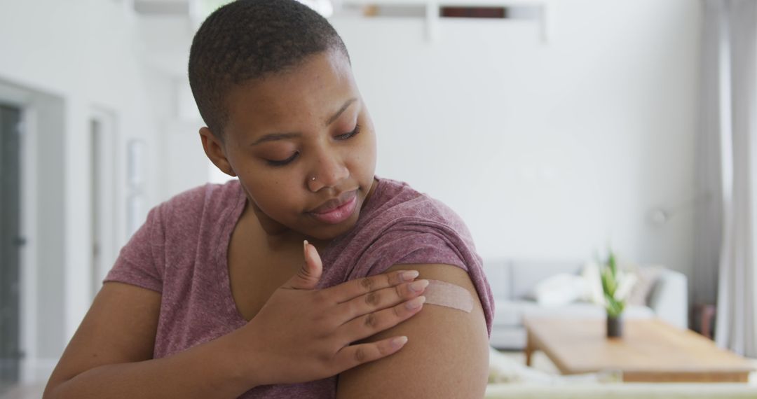 Portrait of smiling african american plus size woman with bandage on her arm after vaccination - Free Images, Stock Photos and Pictures on Pikwizard.com