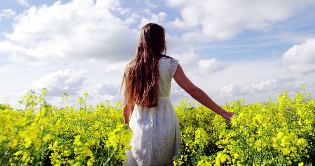 Woman Strolling through Countryside Meadow with Wildflowers - Free Images, Stock Photos and Pictures on Pikwizard.com