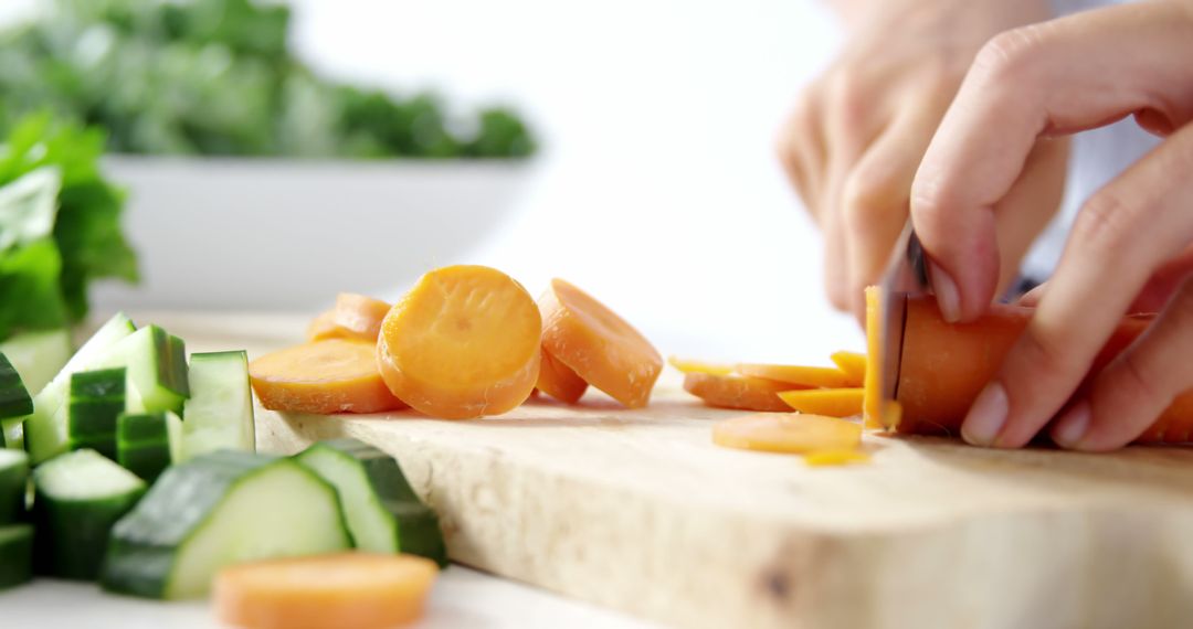 Hands Slicing Vegetables on Wooden Board in Modern Kitchen - Free Images, Stock Photos and Pictures on Pikwizard.com