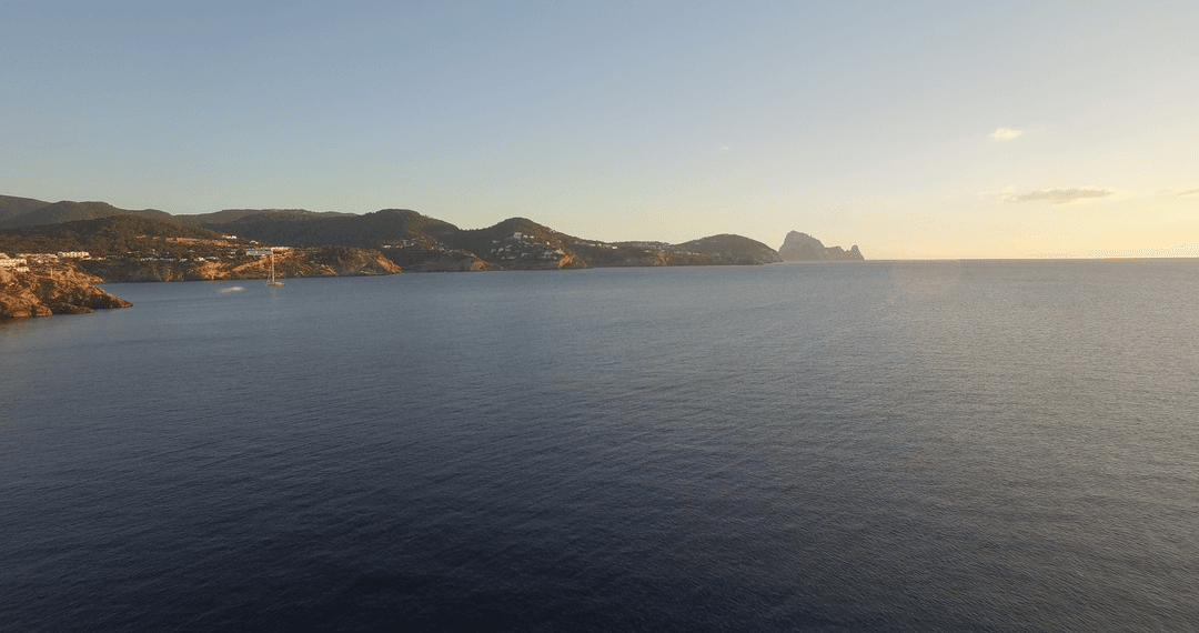 Tranquil ocean horizon at sunset with transparent waters