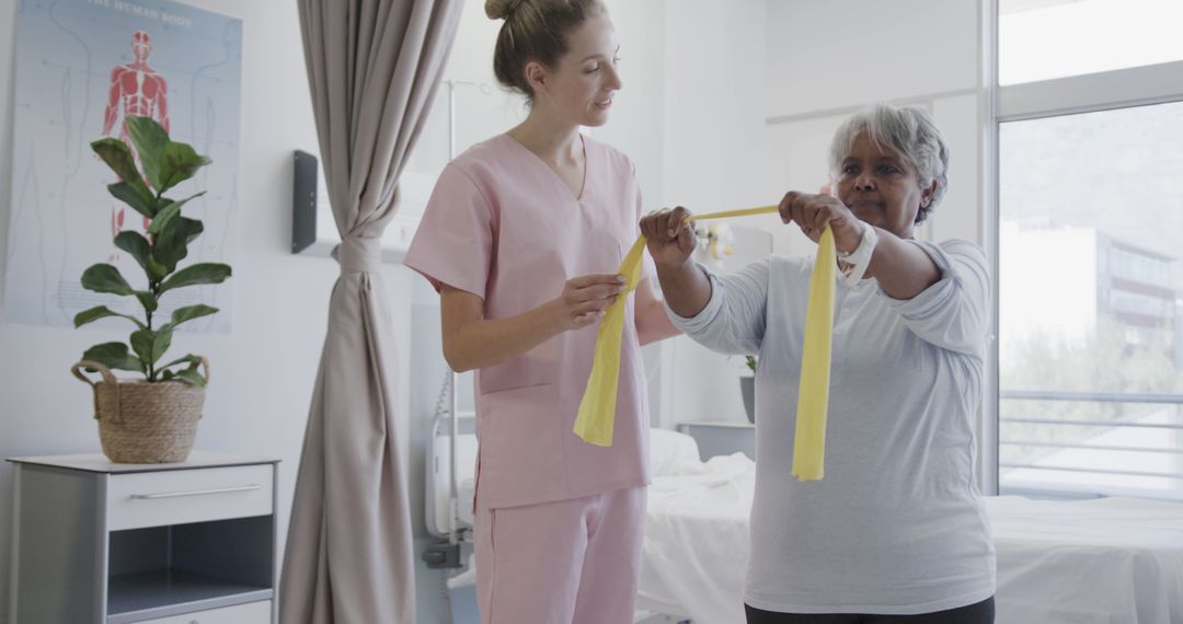 Physical therapist helping elderly woman with resistance band exercises - Free Images, Stock Photos and Pictures on Pikwizard.com