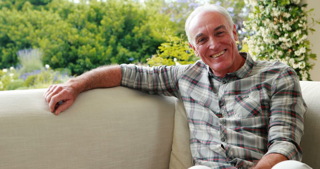 Cheerful senior man relaxing on couch in garden at home - Free Images, Stock Photos and Pictures on Pikwizard.com