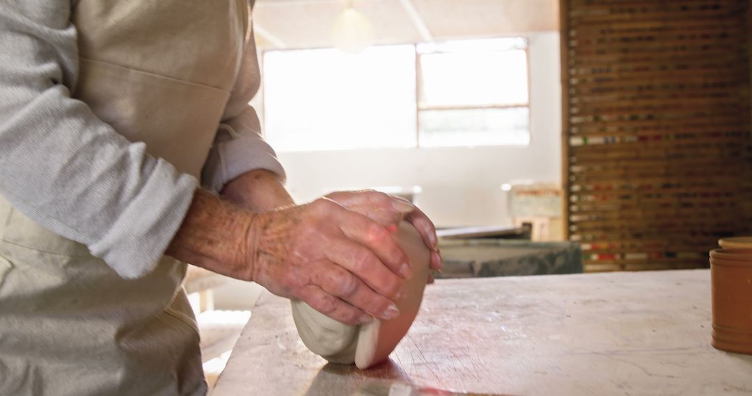 Senior Potter Crafting Clay Pot in Studio - Free Images, Stock Photos and Pictures on Pikwizard.com