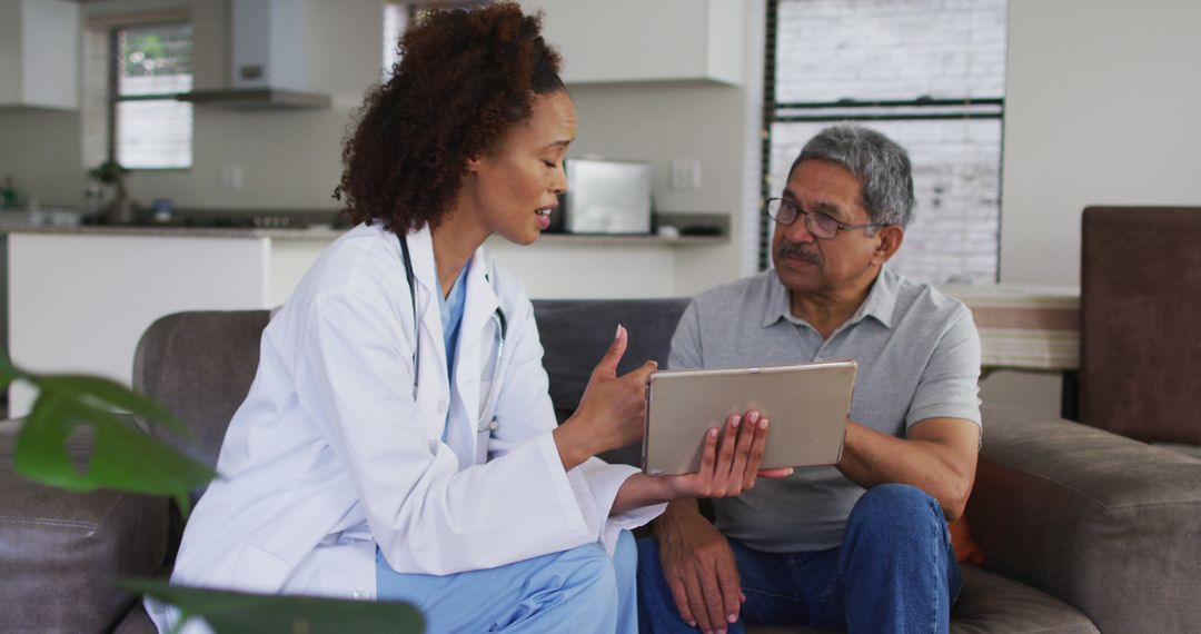 Female Doctor Consulting Elderly Patient at Home Using Tablet - Free Images, Stock Photos and Pictures on Pikwizard.com