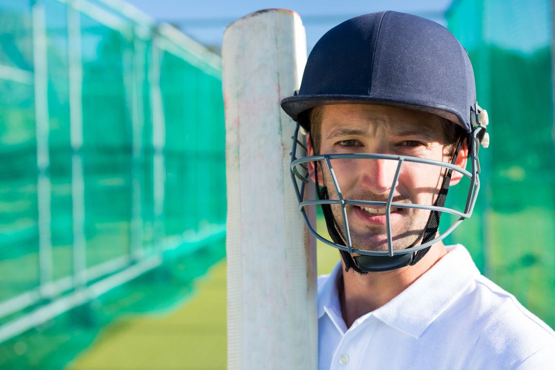 Portrait of cricket player with bat wearing helmet  - Free Images, Stock Photos and Pictures on Pikwizard.com