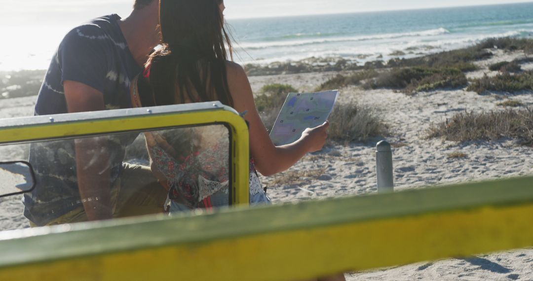 Couple Exploring Beach with Tablet on Sunny Day - Free Images, Stock Photos and Pictures on Pikwizard.com