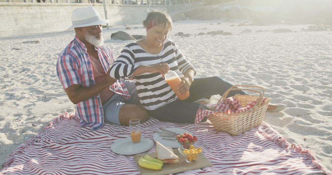 Senior Couple Enjoying Beach Picnic on Sunny Day - Free Images, Stock Photos and Pictures on Pikwizard.com