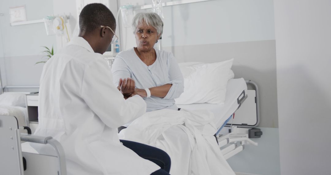 Elderly Woman Discussing with Doctor in Hospital Room - Free Images, Stock Photos and Pictures on Pikwizard.com