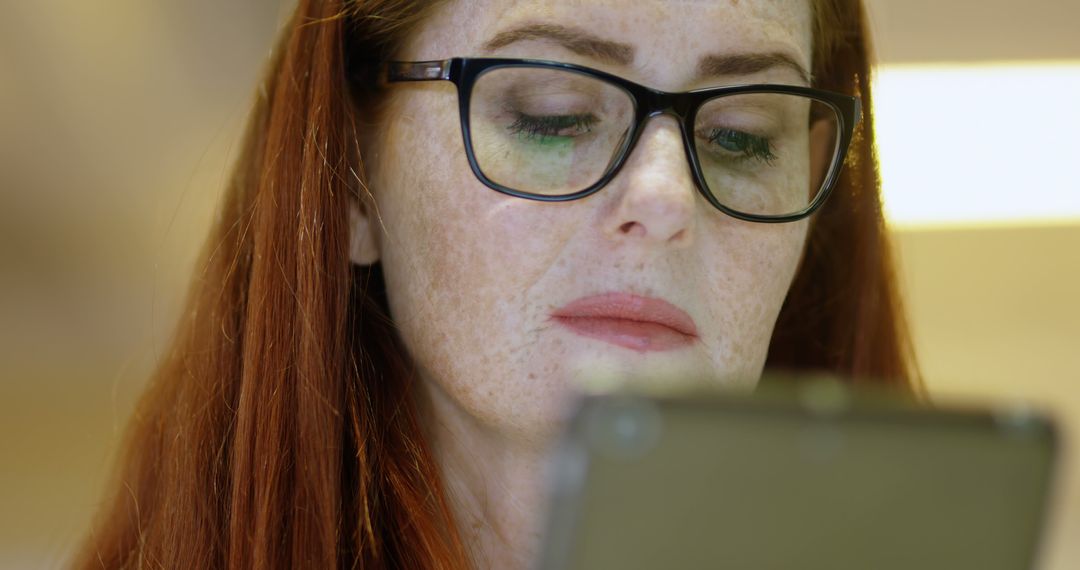 Focused Woman with Glasses Using Tablet Computer - Free Images, Stock Photos and Pictures on Pikwizard.com