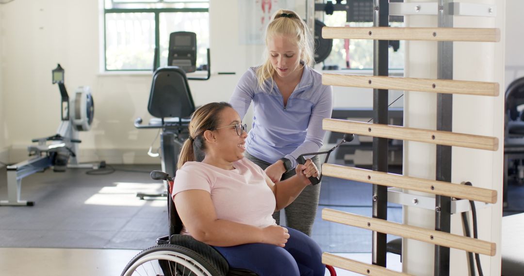 Physical Therapist Assisting Woman with Paraplegia in Exercise Routine