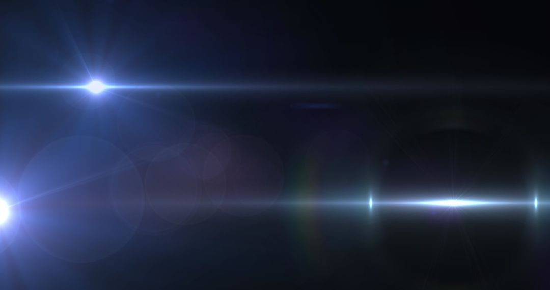 Bright Lens Flare and Dynamic Light Beams on Dark Background