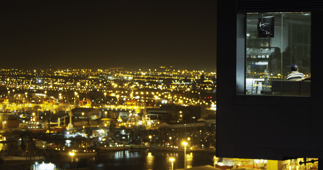 Transparent Urban Nightscape with Office Worker in Window