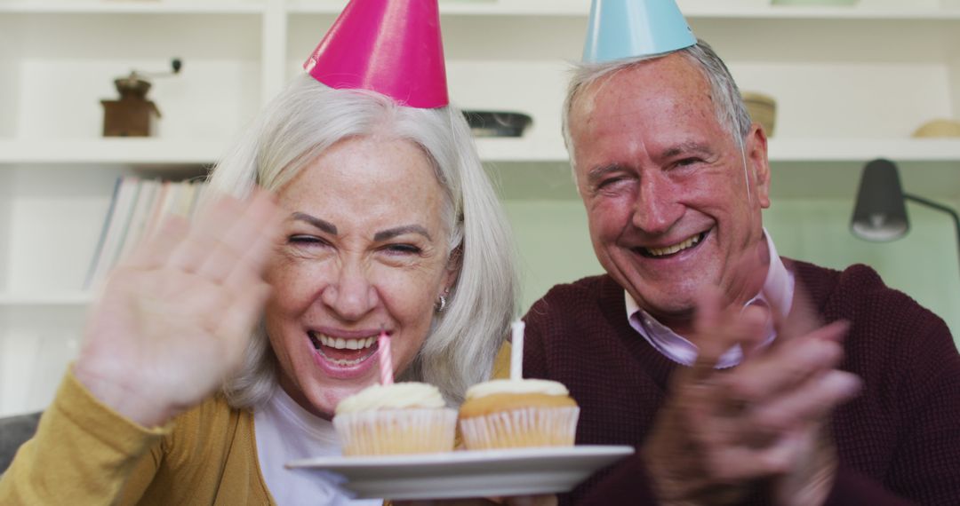 Happy Senior Couple Celebrating Birthday with Cupcakes - Free Images, Stock Photos and Pictures on Pikwizard.com