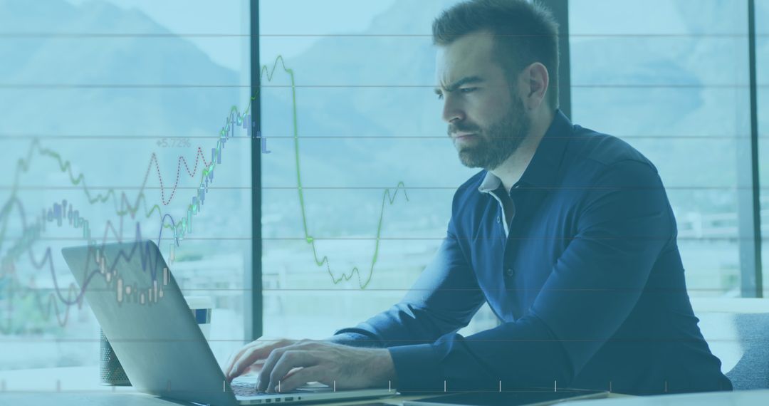 Focused Businessman Analyzing Financial Data on Laptop in Modern Office