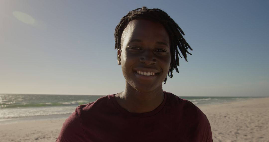 Smiling Young Man at the Beach on a Sunny Day - Free Images, Stock Photos and Pictures on Pikwizard.com