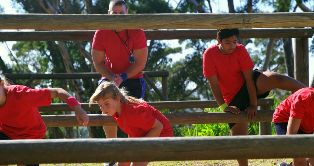 Children Participating in Outdoor Obstacle Course Race with Instructor - Free Images, Stock Photos and Pictures on Pikwizard.com