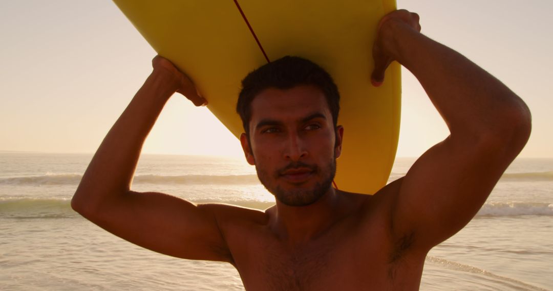 Confident Surfer Holding Surfboard on Sunset Beach - Free Images, Stock Photos and Pictures on Pikwizard.com