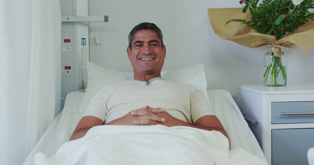 Smiling Male Patient Recovering in Hospital Bed - Free Images, Stock Photos and Pictures on Pikwizard.com