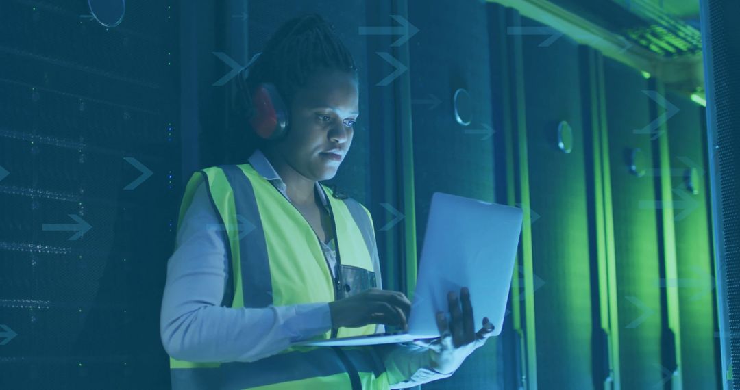 Mid-Adult Technician Examining Server Racks in Data Center