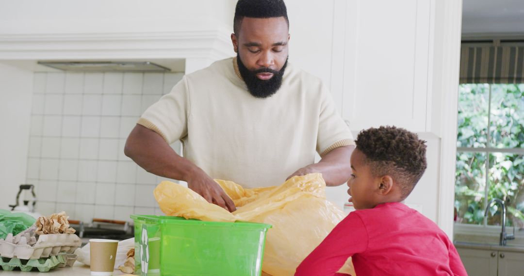 African American Father and Son Sorting Recycling in Kitchen - Free Images, Stock Photos and Pictures on Pikwizard.com