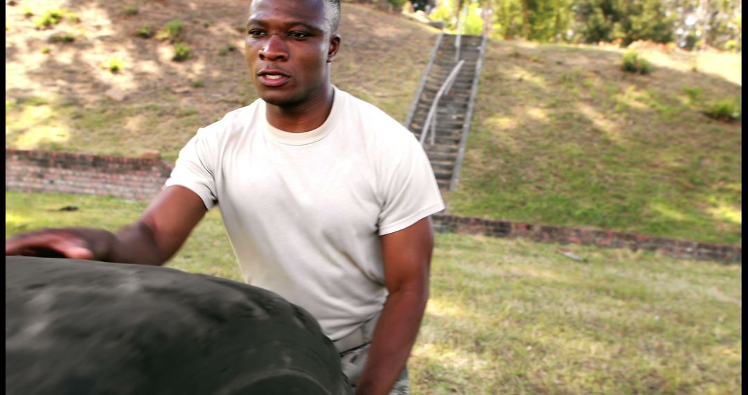 Young African American Man Engaging in Outdoor Tire Workout - Free Images, Stock Photos and Pictures on Pikwizard.com