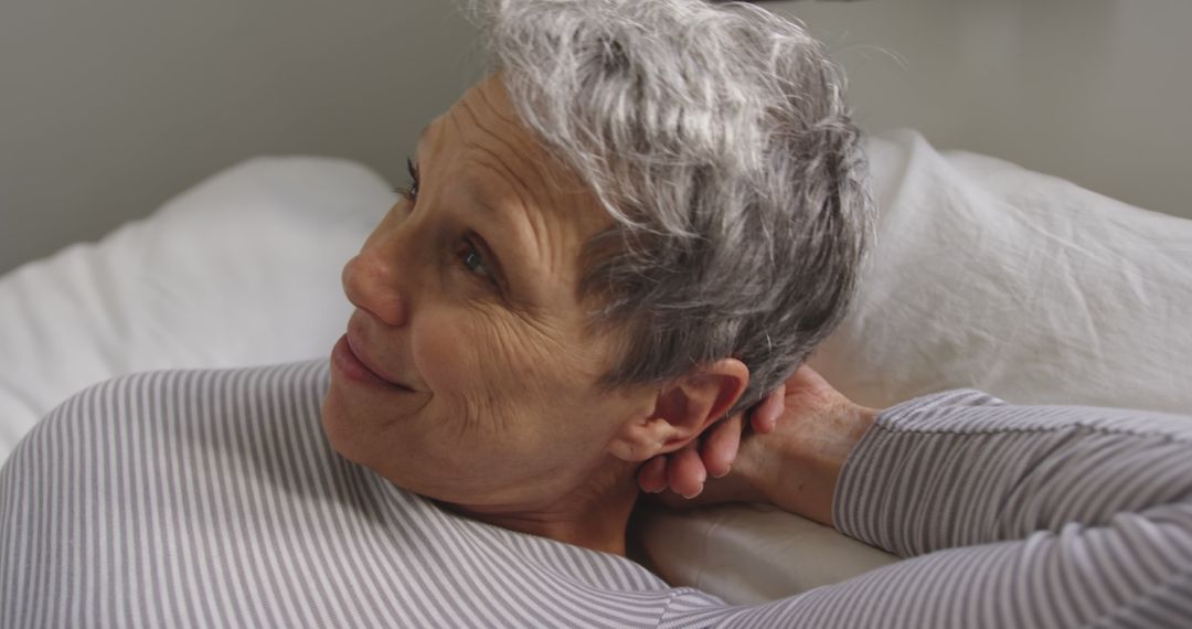 Content Mature Woman with Gray Short Hair Relaxing in Bed - Free Images, Stock Photos and Pictures on Pikwizard.com