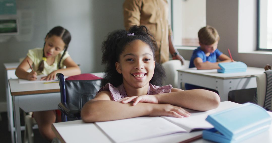 Smiling Girl in Inclusive Classroom at Desk - Free Images, Stock Photos and Pictures on Pikwizard.com