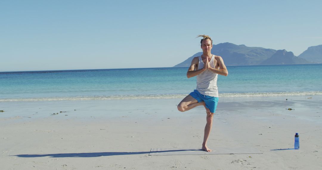 Man Practicing Yoga Tree Pose on Tranquil Beach - Free Images, Stock Photos and Pictures on Pikwizard.com