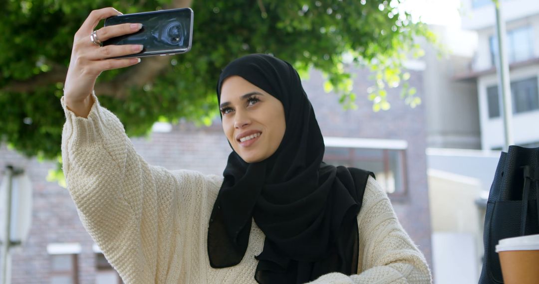 Muslim Woman Taking Selfie Outdoors - Free Images, Stock Photos and Pictures on Pikwizard.com