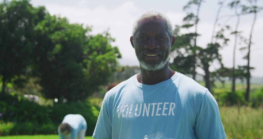 Elderly Man Smiling While Volunteering in Nature - Free Images, Stock Photos and Pictures on Pikwizard.com