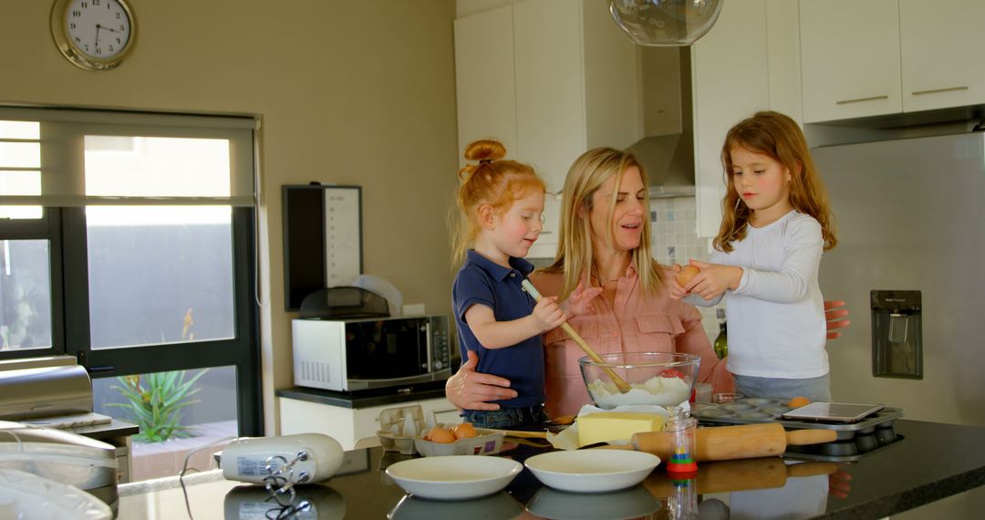 Mother Baking with Young Daughters in Modern Kitchen - Free Images, Stock Photos and Pictures on Pikwizard.com