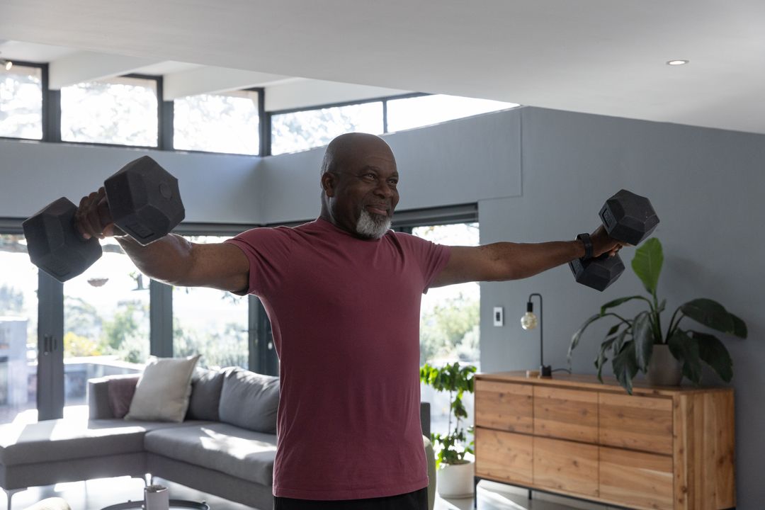 Senior Man Performing Dumbbell Lateral Raises at Home