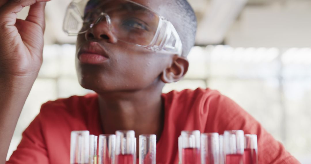 Engaged Student Examining Test Tubes in Science Class Laboratory