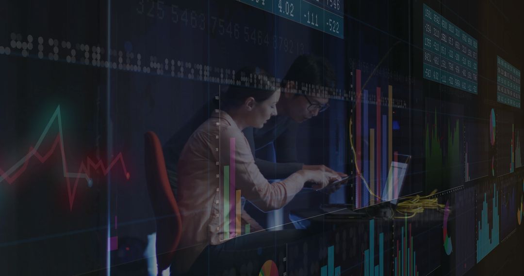 Business Professionals Analyzing Financial Data on Laptop in Trading Room