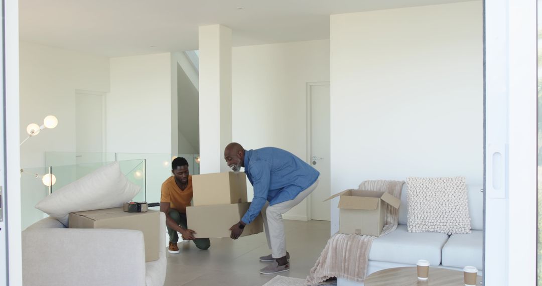 Father and Son Moving Boxes in Modern Living Space