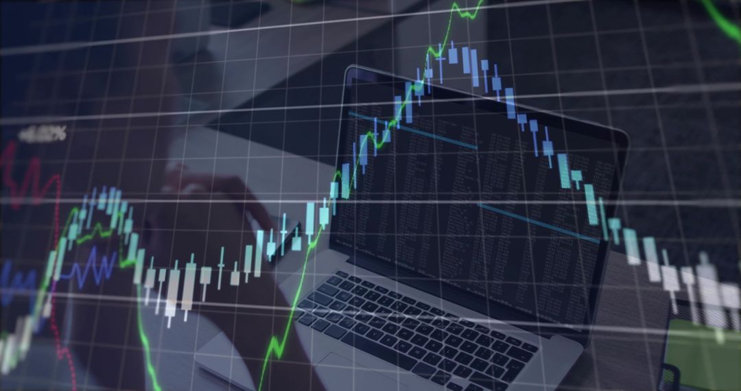 Laptop Displaying Market Data with Candlestick Chart Overlay