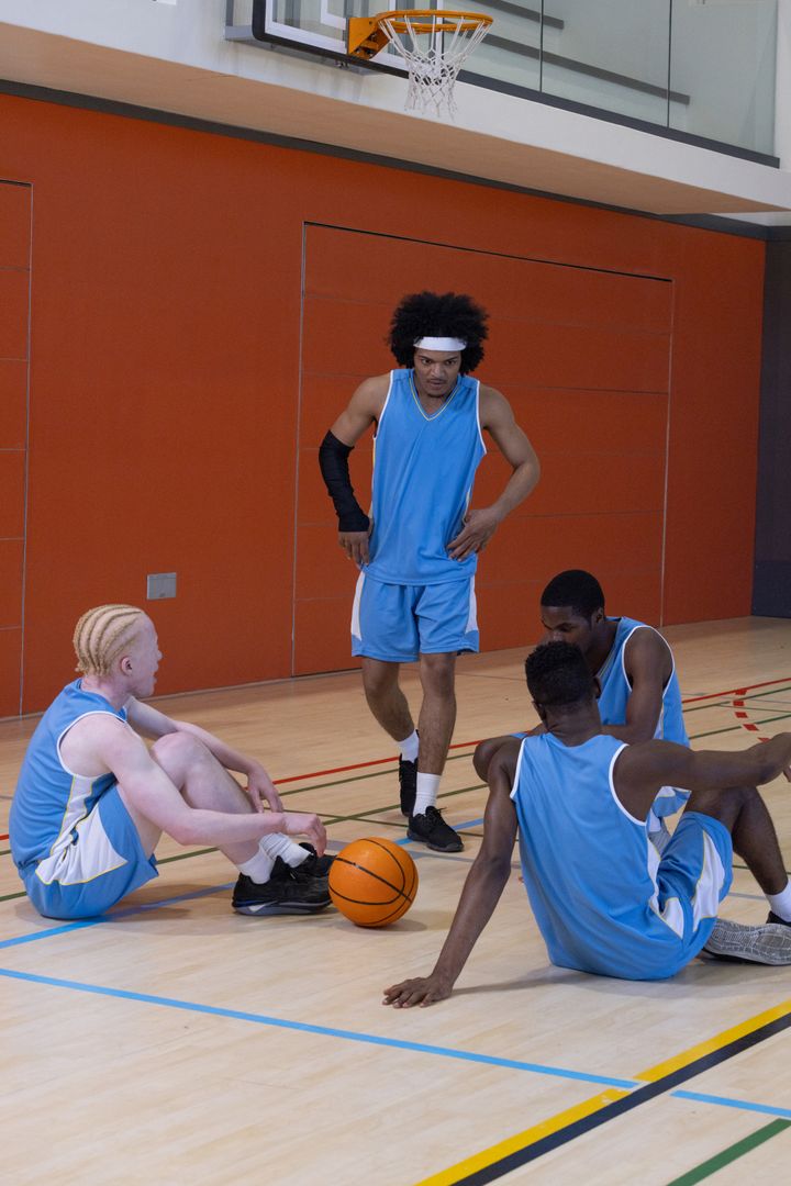 Diverse Basketball Team Strategizing During Practice Session