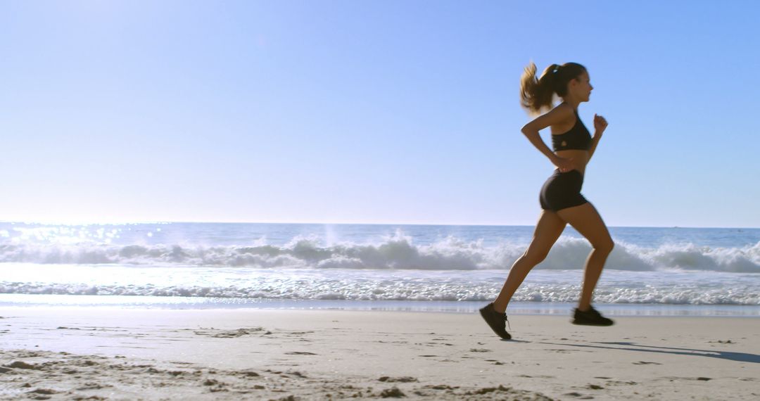 Woman Running on Beach During Summer Morning - Free Images, Stock Photos and Pictures on Pikwizard.com