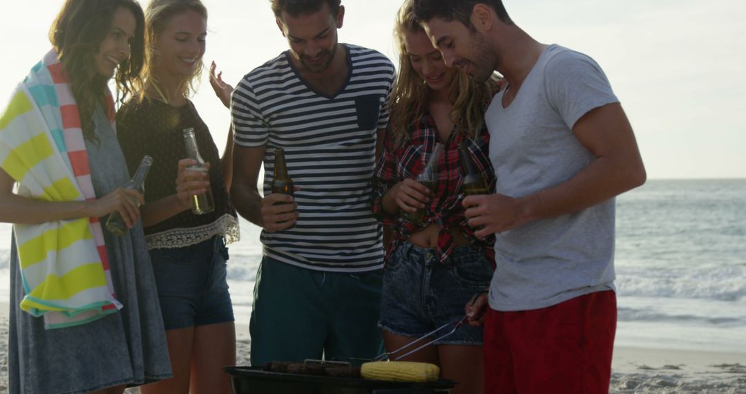 Friends Enjoying Barbecue on Beach at Sunset - Free Images, Stock Photos and Pictures on Pikwizard.com