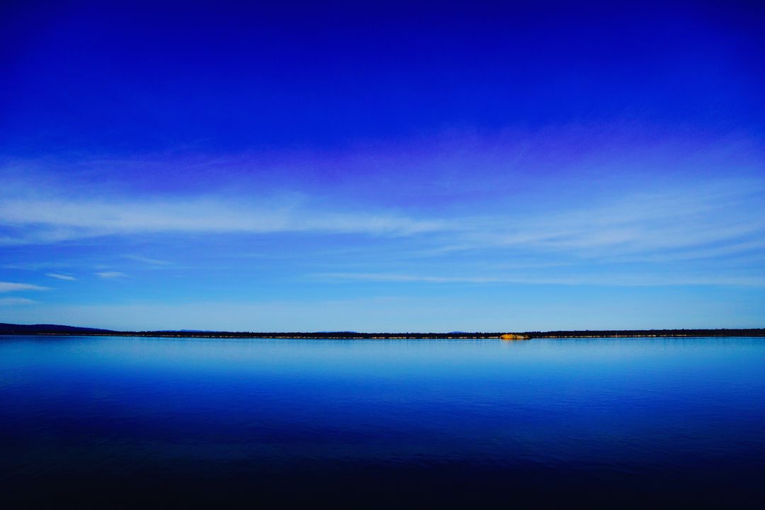 Stunning Blue Sky Reflecting Over Calm Lake at Sunset - Free Images, Stock Photos and Pictures on Pikwizard.com