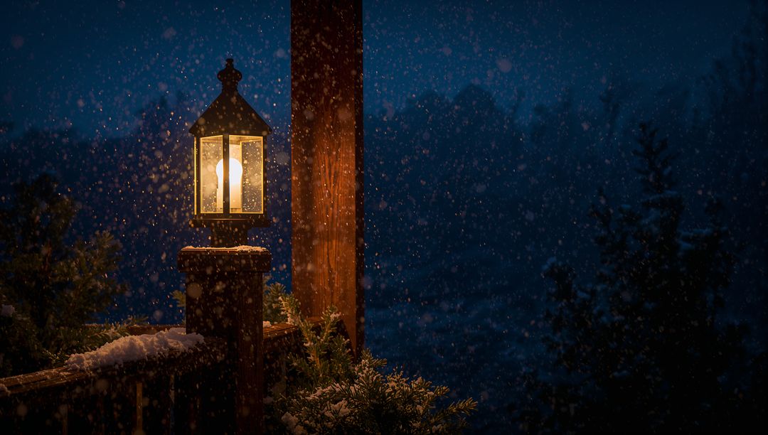 Glowing Lantern on Snowy Cabin Deck Lighting Quiet Winter Night with Falling Snowflakes