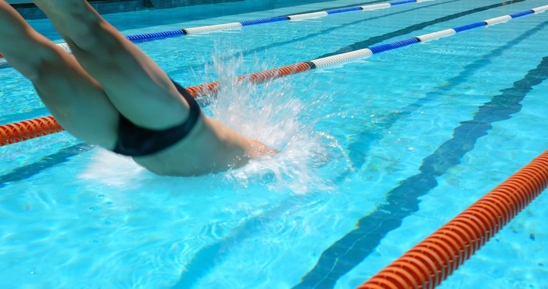 Swimmer Diving into Blue Pool During Competition - Free Images, Stock Photos and Pictures on Pikwizard.com