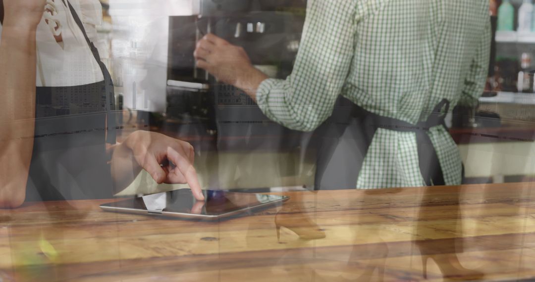 Workers Using Tablet in Busy Cafe Environment