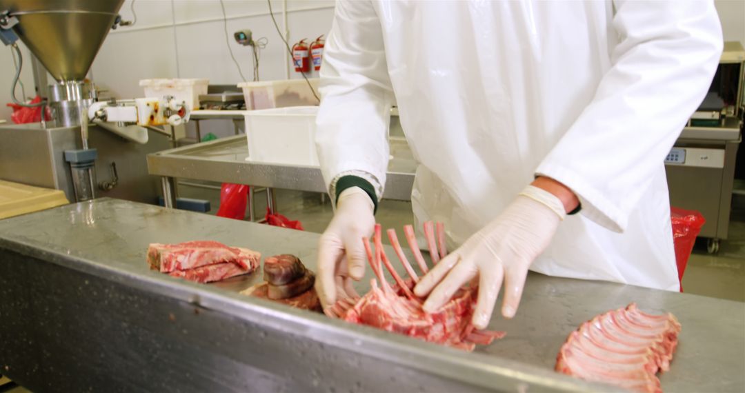 Butcher in White Coat Cutting Raw Meat in Commercial Kitchen - Free Images, Stock Photos and Pictures on Pikwizard.com