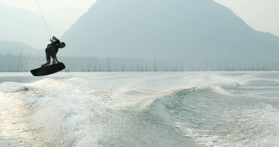 Person Wakeboarding in Scenic Mountain Lake - Free Images, Stock Photos and Pictures on Pikwizard.com