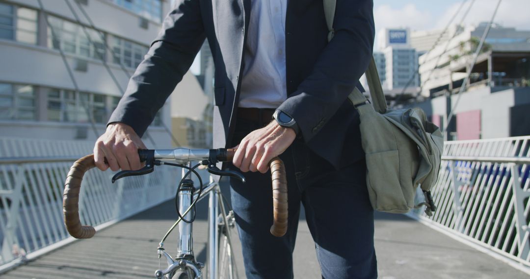 Businessman Commuting by Bike Across City Bridge - Free Images, Stock Photos and Pictures on Pikwizard.com