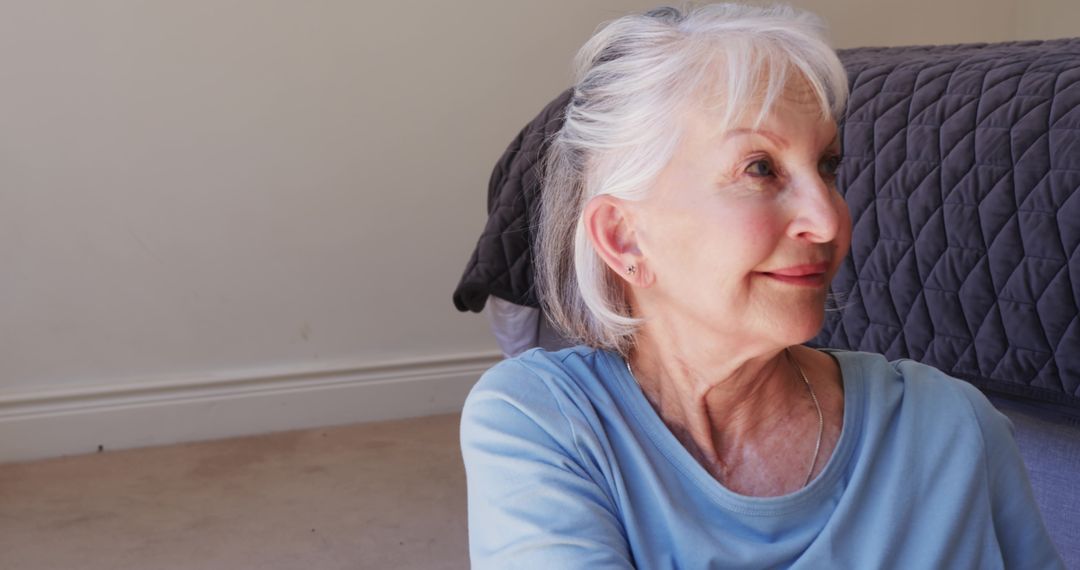 Elderly Woman Relaxing Indoors with Tranquil Expression