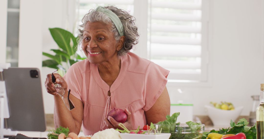 Senior Woman Cooking and Using Tablet for Recipes - Free Images, Stock Photos and Pictures on Pikwizard.com