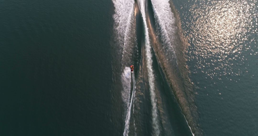 Aerial View of Speedboat Creating Wake Patterns on Water Surface - Free Images, Stock Photos and Pictures on Pikwizard.com