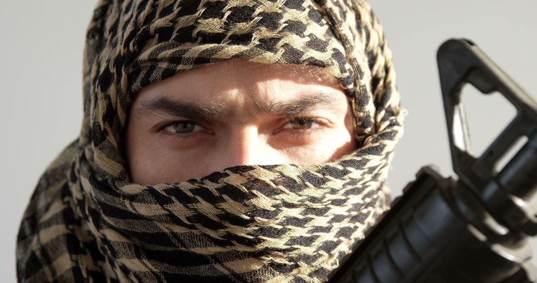 Portrait Soldier with Covered Face Holding a Rifle Focused Gaze - Free Images, Stock Photos and Pictures on Pikwizard.com